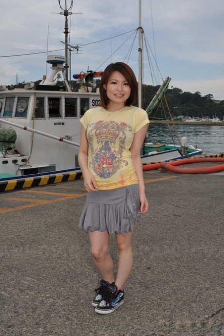 On the docks: Young Japanese girl Miki Uemura poses non-nude in revealing clothing in her skirt.