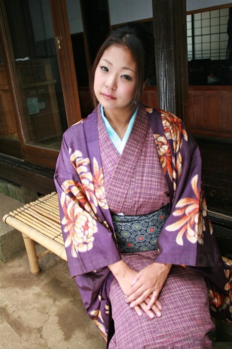 A Japanese woman bares her kimono for a no panty upskirt on the patio.
