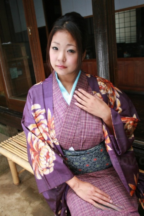 Wearing a no panty upskirt, a Japanese woman pulls up her kimono to wear on the patio.