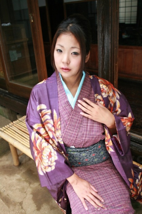 Wearing a no panty upskirt, the Japanese woman pulls her kimono from the patio.