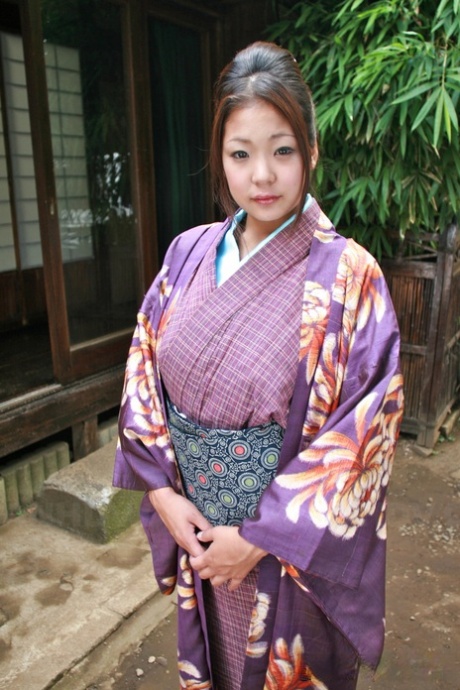 A Japanese woman puts on her kimono without a panty to wear on the patio.