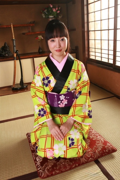 A female in Japan exposes her private parts in traditional attire.