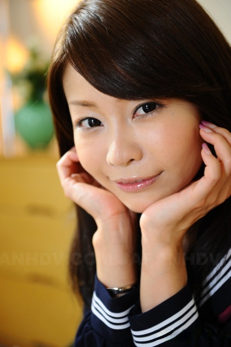 The attractive face of Japanese girl Yuri Aine is highlighted by her choice to wear a sailor suit.