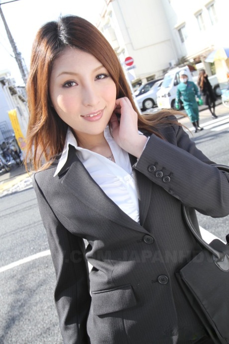 Japanese girl in red gear poses for a photo with her stunning face.