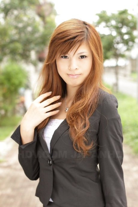 Rina Kikukawa, a beautiful Asian girl, poses in a seductive ensemble while wearing all her clothes on.