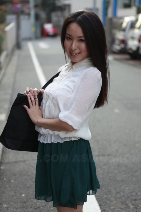 Japan's schoolgirl Anna Sakura stops to admire her beautiful looks on the street.