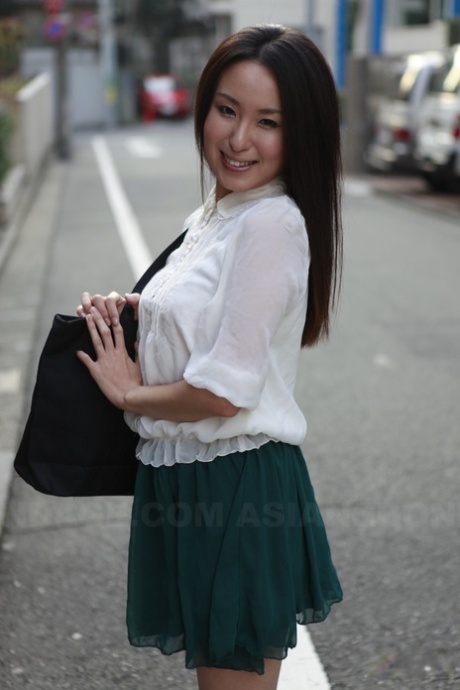 Japanese student Anna Sakura stops to admire her stunning looks on the street.