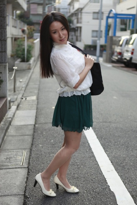 A Japanese schoolgirl named Anna Sakura stops in the street to exhibit her radiant beauty.