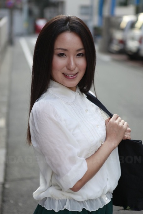 Taking a moment to show off her gorgeous physique, Anna Sakura, a schoolgirl from Japan, stops in the street.