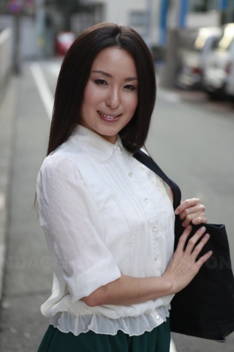 Looking dashing: This Japanese schoolgirl, Anna Sakura (left) stops to pose in the street as she reveals her stunning looks.