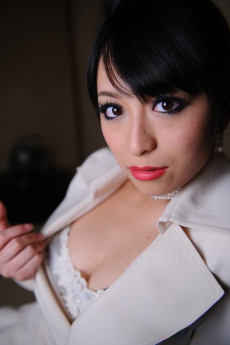 A sophisticated Japanese model named Nana Kunimi flaunts her lace bra and red-lipped lips.