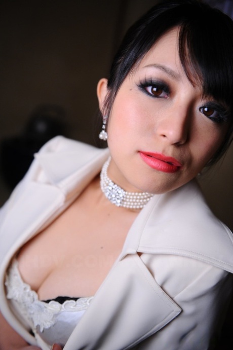 Nana Kunimi, the posh Japanese model, flaunts her lace bra and red lip makeup with pride.