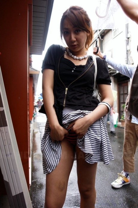 While out in public, Ryo Akanishi, a charming Japanese girl, displays some facial features such as his legs and chest.