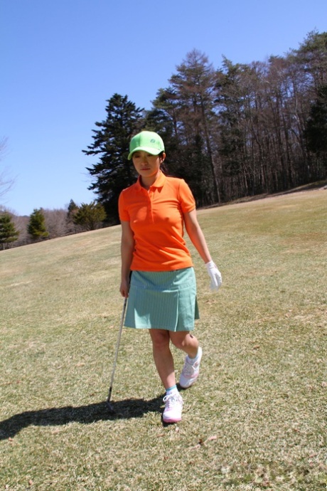 A putt is lined up as Nana Kunimi, a Japanese golfer, flashes without any panties in it.