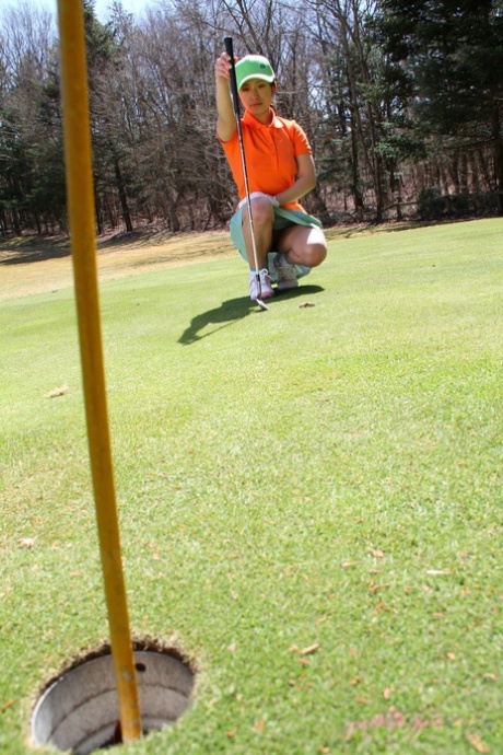 Japanese golfer Nana Kunimi shows no clothing on as he lines up for a putt.