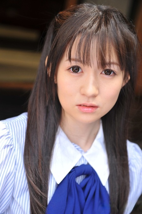 A Japanese beauty named Ai Uehara sits on the balcony and displays her unshaved head.