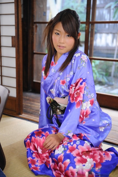 In a classic Kimono dress, Nene Nagasawa, a Japanese woman, exposes her shoulders.
