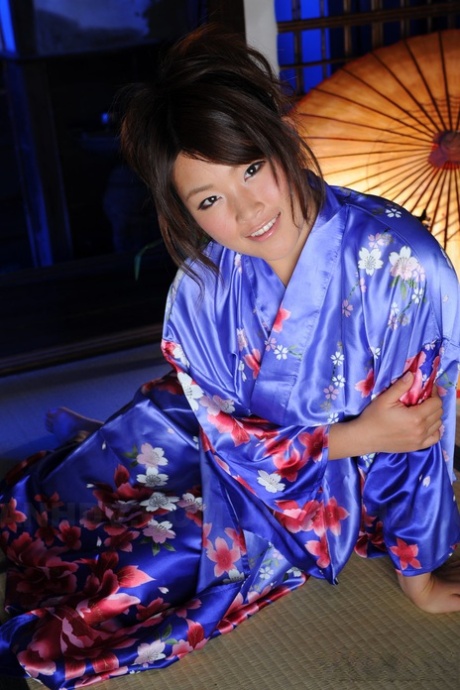 Japanese woman Nene Nagasawa, wearing a traditional Kimono dress, exposes her shoulders in the same attire.