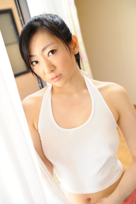 Extends herself on a yoga mat as Japanese MILF Emiko Koike, 30, grabs a breast.