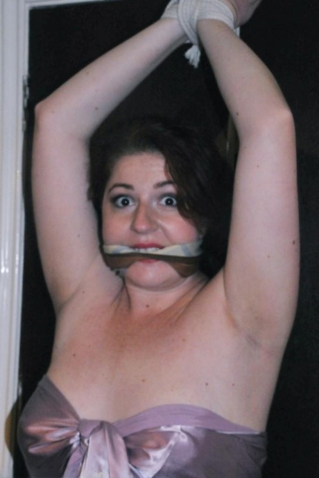 The nipple clamps are used to attach the plumper, a Caucasian plumper, to her nipples, and she is gagged.