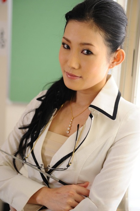 In a classroom, Yui Komine showcases her panties and bra as a Japanese teacher.