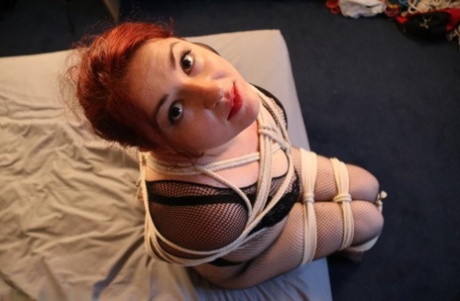 Redheaded Fatty Is Silenced With Medical Tape While Tied Up With Rope On A Bed