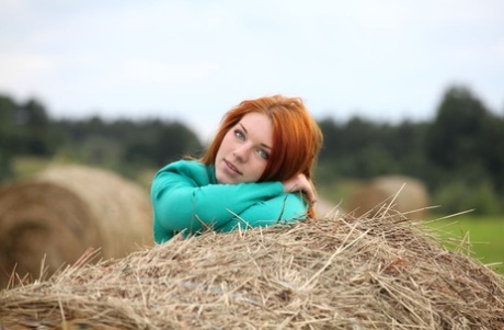 Natural Redhead Amber A Poses Her Naked Teen Body On Round Bale Of Hay