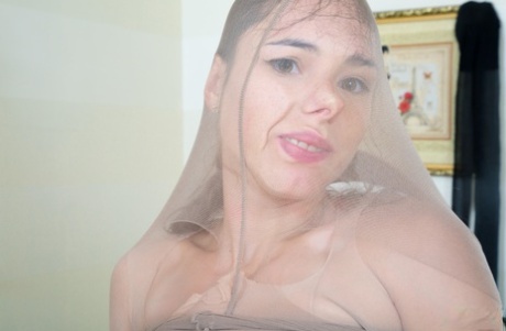 Canella, a single female athlete, covers herself with pantyhose from head to toe.