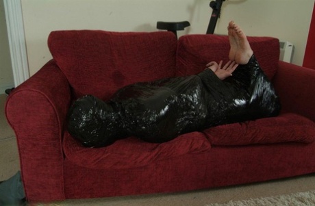 A white female is left balled around and placed in garbage bags while being hogtied.