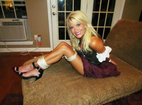 This blonde sexy girl finds herself tied up in various places wearing different clothes.