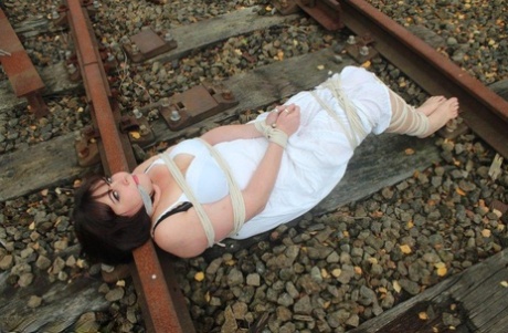 The railway tracks leave Brunette BBW tied up and gagged in a slip.