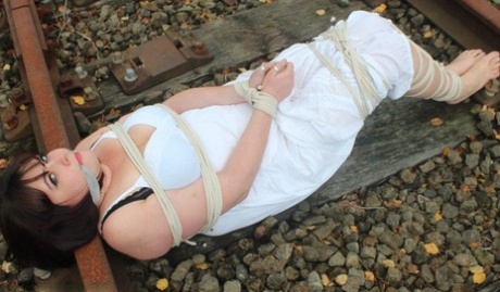 A railway track slip results in Brunette BBW being tied up and gagged.