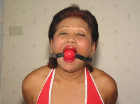 Mature Asian Woman Drools After Being Fitted With A Ball Gag While Restrained
