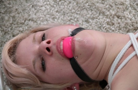 Ball gag and rope bindings are a struggle for the white girl with attractive feet.