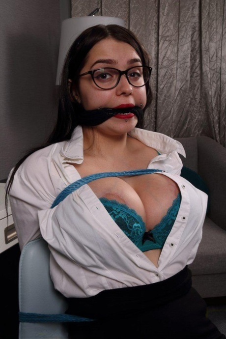 Healthy cleavage is observed on the fully clothed secretary when bound and gagged.