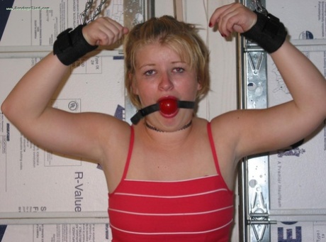 Chubby blonde is fitted with a ball gag before having her breasts exposed