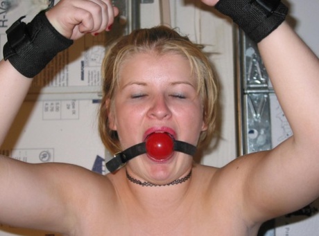 Before having her breasts revealed, the chubby blonde is given a ball gag.