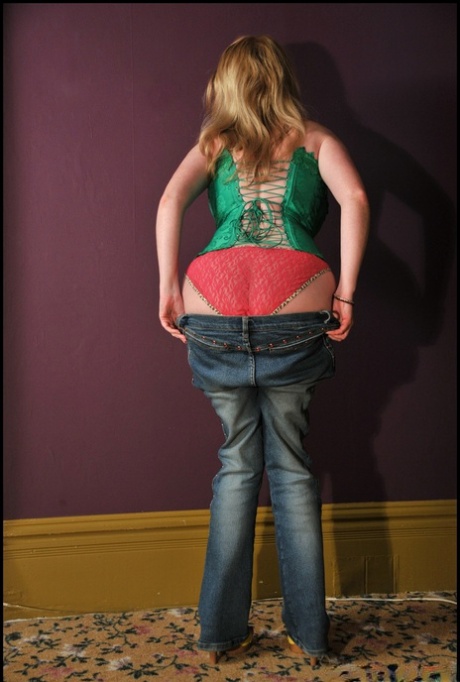 In sexy attire, Tasty Trixie displays her big boobs while wearing blue jeans and an all-in-one bustier.
