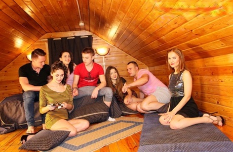 Groups of college students have sex in a log cabin getaway.
