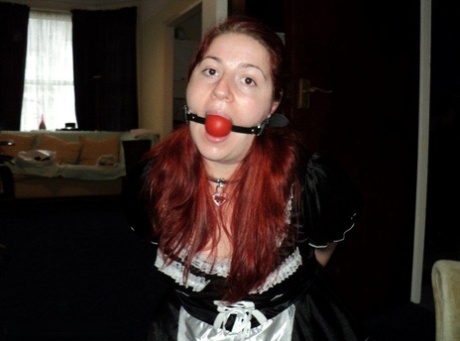This poor maid gets ball bound and handcuffed while at work. She is overweight, has red hair, and feels like she's being a victim of the abuse.