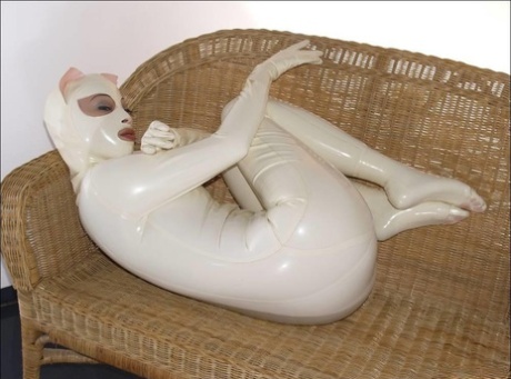 Females wearing rubber clothing model themselves in rubber during a solo engagement.