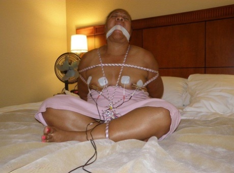 During the time when I was tied up and gagged on my bed, an Ebony fat girl received electrical shocks.