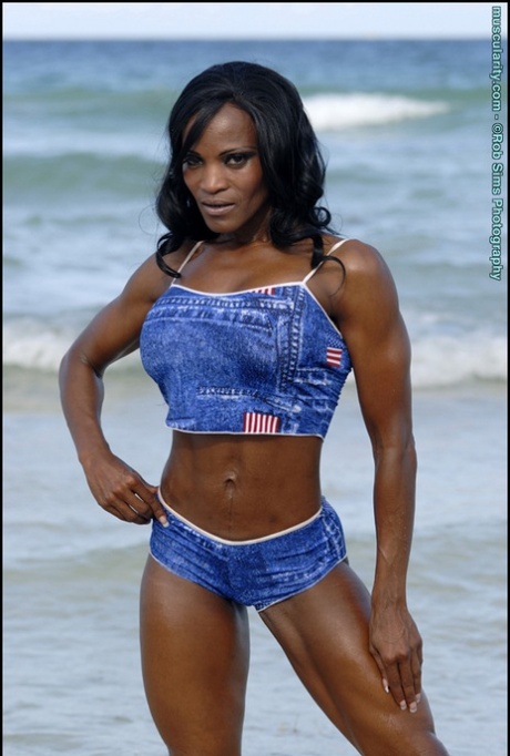 Black Bodybuilder Debra Dunn Flexes Her Muscles At The Beach In Denim Attire