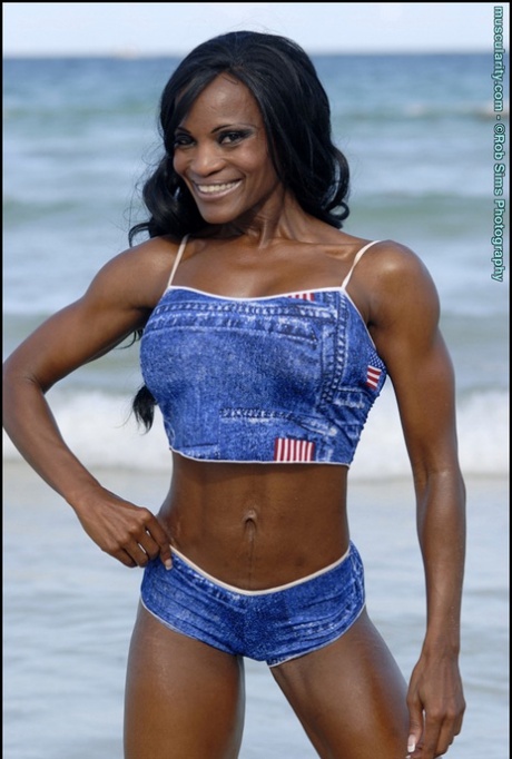 Black Bodybuilder Debra Dunn Flexes Her Muscles At The Beach In Denim Attire