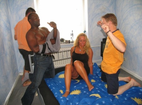 In the midst of being staged by black and white males, an amateur with blonde hair is gangbanged onto her bed.