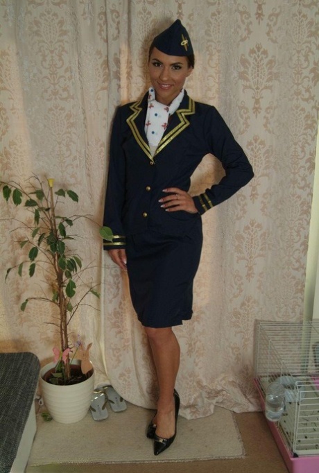 Struggling against the handcuffs, a flight attendant touches up her skirt.