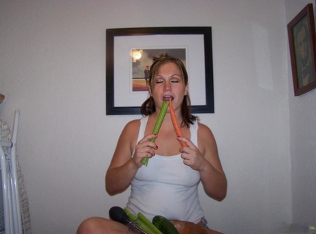 Involved woman Toni Fay pleasures herself by placing her hands on vegetables and masturbating them on a table.