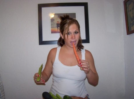At a table orchard, Toni Fay (left), an amateur woman, pleasures herself by placing her hands on vegetables and masturbating on the floor.