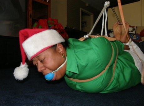 Bogged down in her Santa hat, the overweight black woman is being ball-stamped by him.