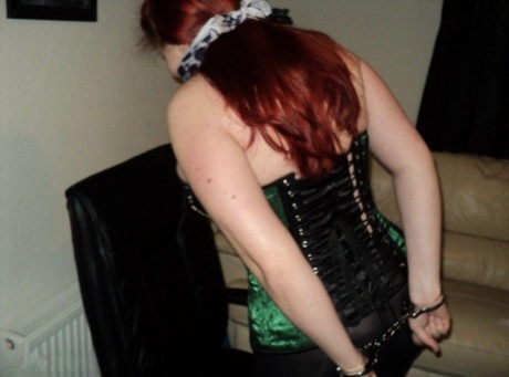 With her hands cuffed behind her back, Chubby redhead performs the classic "take off" cleave gag.